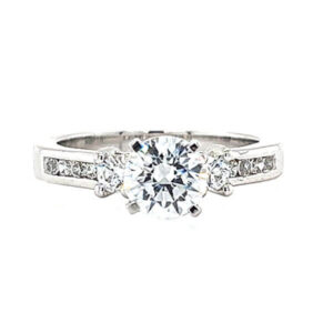 Engagement ring with channel set diamond melee, prong set diamond melee and a 4 prong peg head