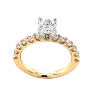 Engagement ring set with shared prong diamond melee and a 4 prong peg head 