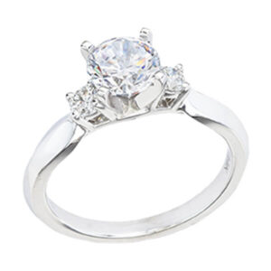 Three stone diamond ring in white gold with prong set side diamond melee