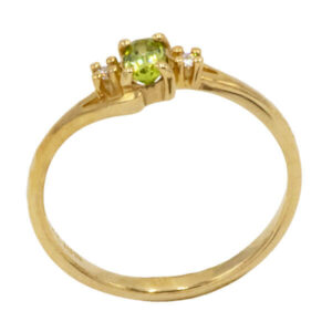Oval cut green peridot ring with diamonds in a yellow gold setting