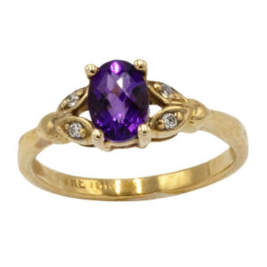 Oval cut amethyst with diamonds in a vintage style yellow gold setting