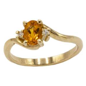 Oval cut orange citrine & diamond ring in a yellow gold setting