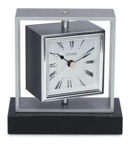 Citizen decorative desk clock, square aluminum frame in brushed finish, seated on black crystal base. The fitup can be rotated by 360 degree. Aluminum dial in vertical brushed finish. Printed black raised Roman numerals at all hours. Acrylic lens. Custom engravable plate is included. Sweep second hand.